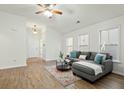 Bright living room featuring wood flooring, neutral walls, and a comfortable gray sectional at 3802 Annapolis Way, Ladson, SC 29456