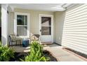 Cozy covered porch with seating offers a charming spot to relax and enjoy the outdoors at 3802 Annapolis Way, Ladson, SC 29456