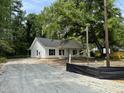 New construction white home with black shutters, situated on a lot filled with mature trees at 419 Ravenwood Rd, Walterboro, SC 29488
