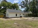 The rear of this home offers a covered patio, perfect for enjoying the outdoors, and a spacious yard at 419 Ravenwood Rd, Walterboro, SC 29488