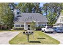 Inviting single-story home with a well-kept lawn, landscaping, and a convenient driveway for parking at 4807 Habersham Ln, Summerville, SC 29485