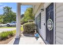 Cozy front porch entrance with classic columns and welcoming decorations, creating a charming curb appeal at 4807 Habersham Ln, Summerville, SC 29485