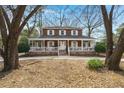 Charming two-story home with a classic wrap-around porch, situated on a lot with mature trees offering natural beauty at 49 Crosscreek Dr, Charleston, SC 29412
