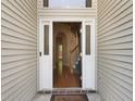 Open doorway reveals hardwood floors and stairs with white trim and a Welcome mat at 5418 Percival Ln, Charleston, SC 29420