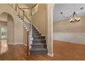 Foyer with hardwood floors leading to carpeted stairs and an archway to the dining room at 5418 Percival Ln, Charleston, SC 29420