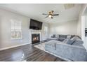 Bright living room featuring a corner fireplace, ceiling fan, and an extra large comfy sectional couch at 603 Curing Ct, Moncks Corner, SC 29461