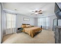 Serene bedroom features plush carpeting, a ceiling fan, a king bed, and streams of natural light at 603 Curing Ct, Moncks Corner, SC 29461