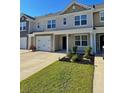 Well-manicured lawn highlights this townhome with an attached garage and a welcoming 'Welcome' sign at 703 Hilchot Dr, Summerville, SC 29486