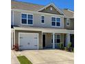 Charming townhome with attached garage and covered entryway, complemented by a well-maintained lawn at 703 Hilchot Dr, Summerville, SC 29486
