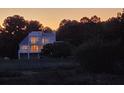 House exterior at sunset featuring a partial view through surrounding trees at 7997 Doar Rd # C-3, Awendaw, SC 29429