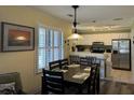 Bright dining area featuring white cabinets and modern appliances adjacent to the kitchen at 855 Club Cottage Rd, Edisto Island, SC 29438