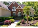 Inviting front entrance with brick steps, lush landscaping, and an elegant double door at 8642 W Fairway Woods Dr, North Charleston, SC 29420