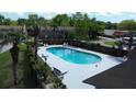 A refreshing community pool, perfect for relaxation and socializing with surrounding palm trees and lounge chairs at 870 Colony Dr # A6, Charleston, SC 29407