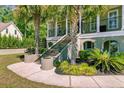 Beautifully landscaped front yard with palm trees and lush greenery, enhancing curb appeal at 105 Aviary Ct, Summerville, SC 29483