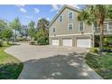 Spacious three-car garage with a large driveway, perfect for multiple vehicles and easy access at 105 Aviary Ct, Summerville, SC 29483