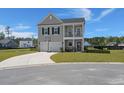 Charming two-story home with a front porch, two-car garage, basketball hoop, and a well-manicured lawn at 118 Jesup Ct, Ridgeville, SC 29472
