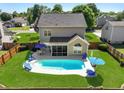 Aerial view of a backyard with a sparkling pool, lounge chairs, and a screened patio at 118 Netherfield Dr, Summerville, SC 29486