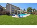 Inviting backyard with a sparkling pool, lounge chairs, and a screened patio for outdoor relaxation at 118 Netherfield Dr, Summerville, SC 29486