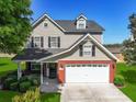 Beautiful two-story home featuring a well-kept lawn, and a brick and siding exterior at 118 Netherfield Dr, Summerville, SC 29486