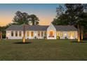 A single-story home with black trimmed windows, palm trees, and an expansive green lawn at 1183 Farm Quarter Rd, Mount Pleasant, SC 29464