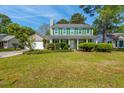 Charming two-story home with green shutters, a manicured lawn, and attached two car garage at 119 Alwyn Blvd, Summerville, SC 29485