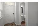 Home entryway with a white front door, a small rug, and a view of a half bathroom at 121 Dream St, Summerville, SC 29483