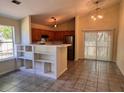 Open kitchen with stainless steel appliances, bar seating, and dining area with sliding doors to outdoor space at 124 Droos Way, Charleston, SC 29414
