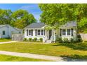 Well-maintained home with black shutters, freshly cut grass, and a sidewalk at 1324 Maxwell St, North Charleston, SC 29405