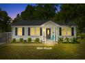 Charming home featuring a cozy front porch with a brightly colored chair and well-maintained landscaping at 1324 Maxwell St, North Charleston, SC 29405