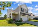 Side view of a two-story home with a covered porch and well-maintained lawn at 136 Pontoria Dr, Summerville, SC 29483