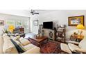 Cozy living room featuring a ceiling fan, comfortable seating, and a decorative rug at 1411 Thin Pine Dr, Johns Island, SC 29455