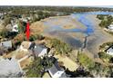 Waterfront home featuring a marsh view, mature trees, and convenient access to the waterway at 1481 Battery Reynolds Ct, Charleston, SC 29412