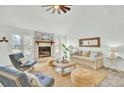 Bright living room features vaulted ceilings, a stone fireplace, and a neutral color palette at 1481 Battery Reynolds Ct, Charleston, SC 29412