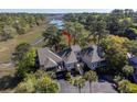 Stunning aerial view of the property surrounded by lush trees and serene marshland, showcasing its prime location at 1502 Marsh Haven, Seabrook Island, SC 29455