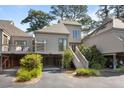 Charming coastal home with elevated design, lush landscaping, and convenient parking, located in a serene community at 1502 Marsh Haven, Seabrook Island, SC 29455