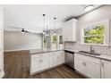 Open kitchen and living space featuring white cabinets, granite countertops, and stainless steel appliances at 1518 Stanwick Dr, Johns Island, SC 29455