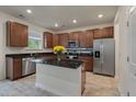 Modern kitchen with stainless steel appliances, granite countertops and a center island at 153 Caleb Ct, Ladson, SC 29456