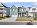 Beautifully designed two-story home with a welcoming front porch and well-manicured lawn at 1541 Homecoming Blvd, Ravenel, SC 29470