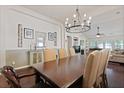 Elegant dining room with a decorative chandelier and access to the living area at 177 Sugar Magnolia Way, Charleston, SC 29414