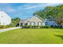 Charming single-story home with a well-manicured lawn and neatly trimmed hedges, enhancing its curb appeal at 1929 Treebark Dr, Charleston, SC 29414