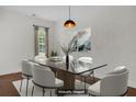 Dining room with a glass-top table, six chairs, hardwood floors, and recessed lighting at 1953 Suzanne St, Johns Island, SC 29455