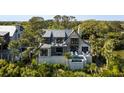 Beautiful home featuring a pool, balcony, and lush greenery, offering the ultimate in luxurious outdoor living and privacy at 20 Old Cedar Ln, Kiawah Island, SC 29455