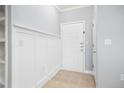 A clean, light gray entryway with white trim and a white door, creating a bright and inviting space at 200 Bucksley Ln # 302, Charleston, SC 29492