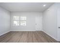 Bright living room featuring wood-look flooring, neutral paint, and ample natural light at 205 W Bradford Pointe Dr, Summerville, SC 29483
