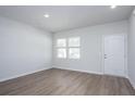 Bright living room featuring wood-look flooring, neutral paint, and ample natural light at 205 W Bradford Pointe Dr, Summerville, SC 29483