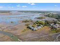 Stunning aerial view of waterfront community with docks and extensive marshlands at 2105 Landfall Way, Seabrook Island, SC 29455