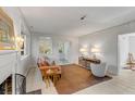 Bright living room with a fireplace, light walls, a brown rug, and large windows at 2137 Wappoo Dr, Charleston, SC 29412