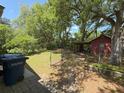 Spacious backyard featuring a shed, mature trees, and partial fence for privacy at 2438 Two Oaks Dr, Charleston, SC 29414