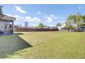 A large, grassy backyard bordered by a wooden fence, perfect for outdoor activities and entertaining at 2746 Sunrose Ln, Johns Island, SC 29455