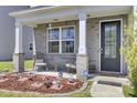 Inviting front porch with seating area and decorative accents providing a welcoming entrance at 2746 Sunrose Ln, Johns Island, SC 29455